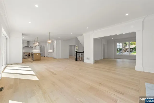 a spacious bedroom with a large bed and a flat screen tv