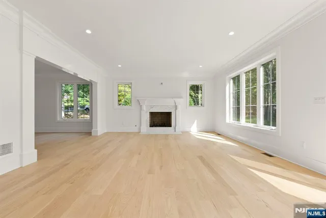 a spacious bedroom with a bed and a view of bedroom