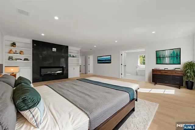 a bathroom with a toilet a sink a mirror a bathtub and vanity