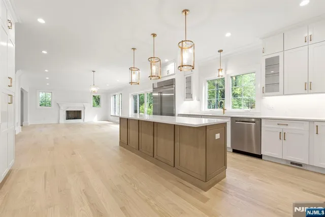 a view of an empty room with a fireplace and a window