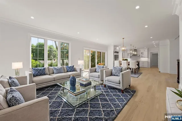 a view of an empty room and kitchen view