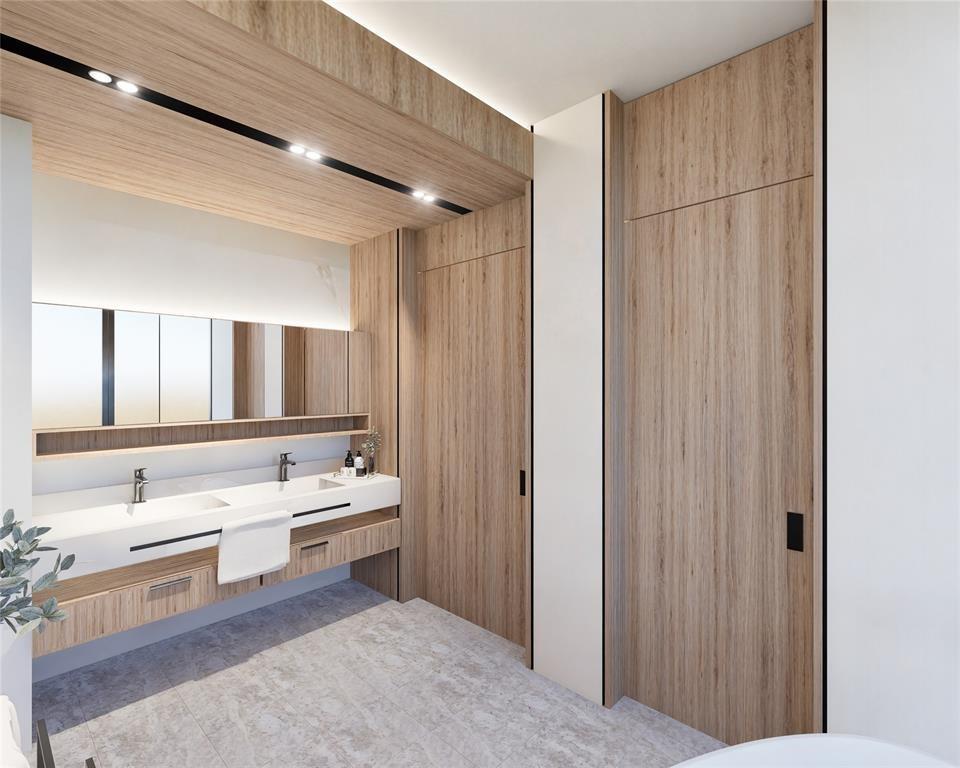 4930 Northeast 28th Avenue Lighthouse Point, FL 33064 - Photo 14 of 22 a bathroom with a double vanity sink a mirror and a bathtub