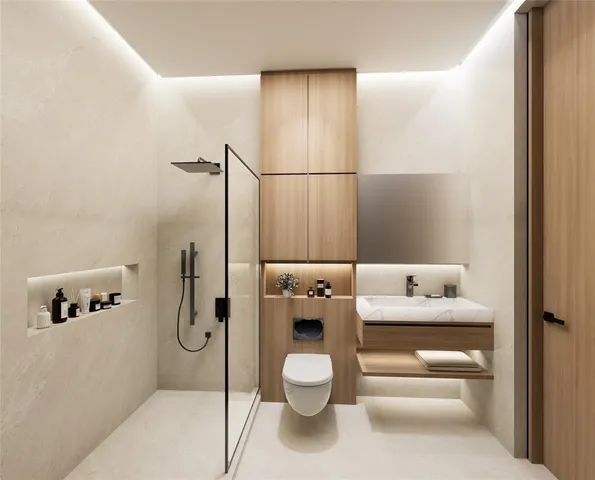 a bathroom with a granite countertop sink a toilet and shower