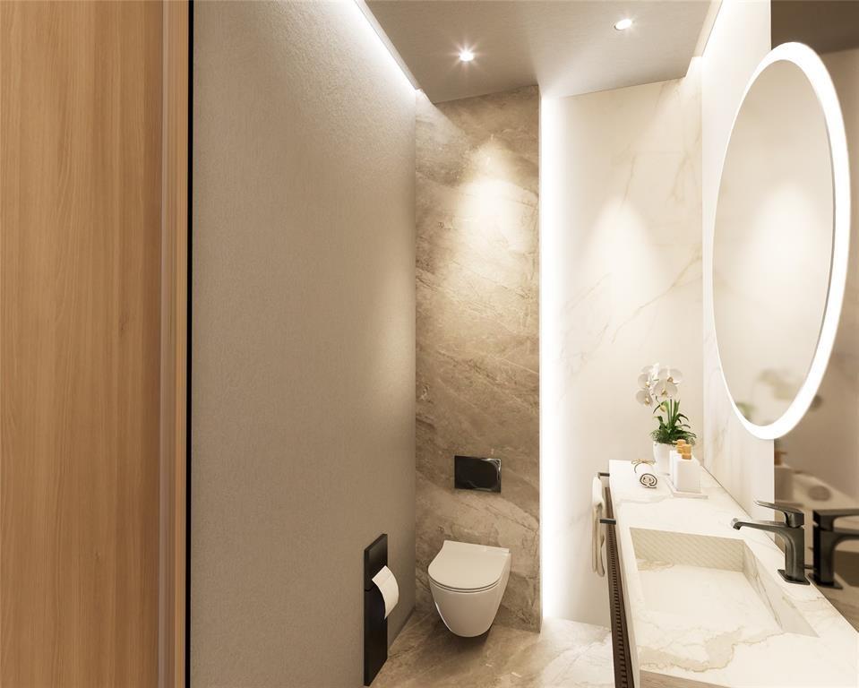 4930 Northeast 28th Avenue Lighthouse Point, FL 33064 - Photo 20 of 22 a bathroom with a sink a toilet and a mirror