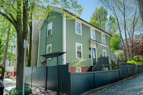 a view of a house with a backyard