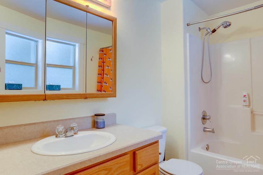 17020 Glendale Road Bend, OR 97707 - Photo 11 of 24 a bathroom with a sink toilet a mirror and shower
