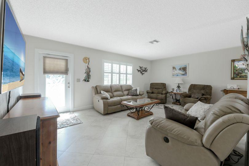 5547 3rd Road Lake Worth, FL 33467 - Photo 4 of 34 a living room with furniture and a flat screen tv