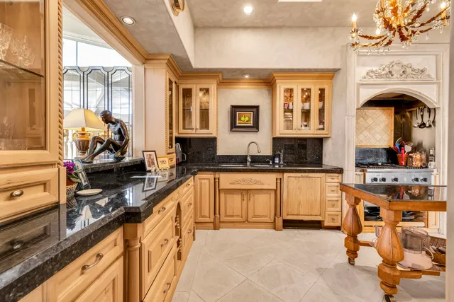 a kitchen with stainless steel appliances granite countertop a sink and cabinets