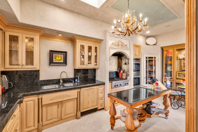 a kitchen with stainless steel appliances granite countertop a stove and a refrigerator