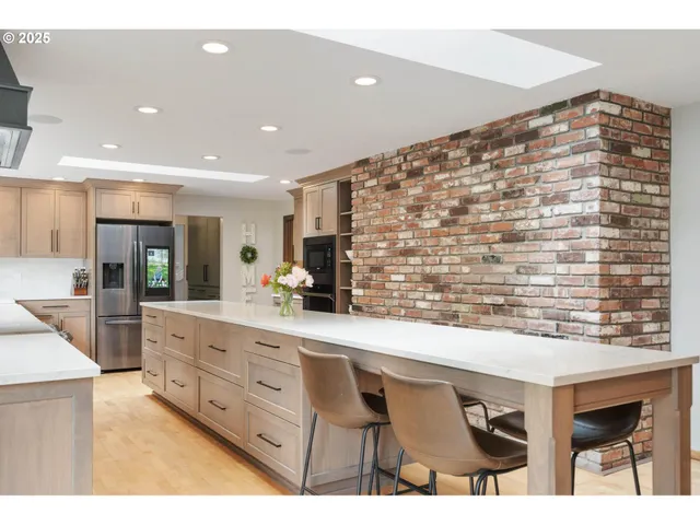 a kitchen with stainless steel appliances kitchen island granite countertop a cabinets and a counter top space