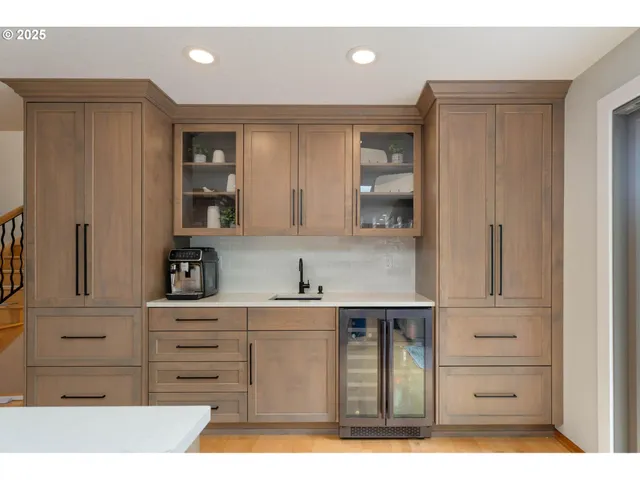 a kitchen with a refrigerator and cabinets