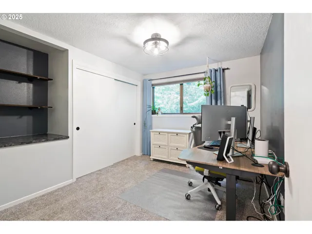 a bathroom with a toilet sink mirror vanity and window