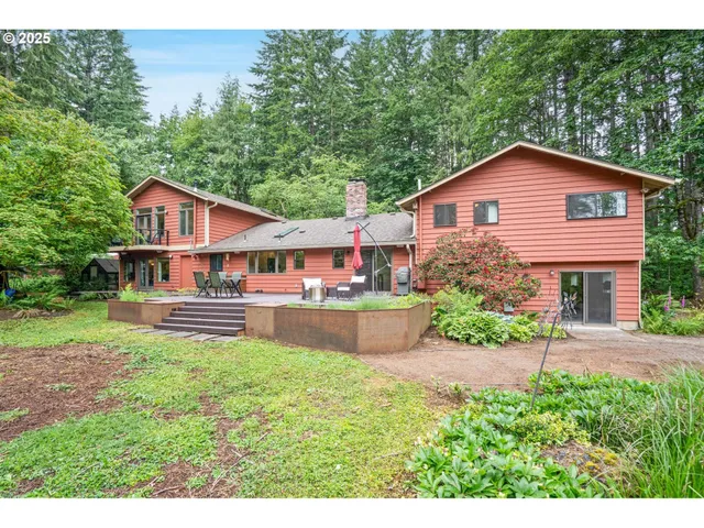 a view of a house with a small yard and garage