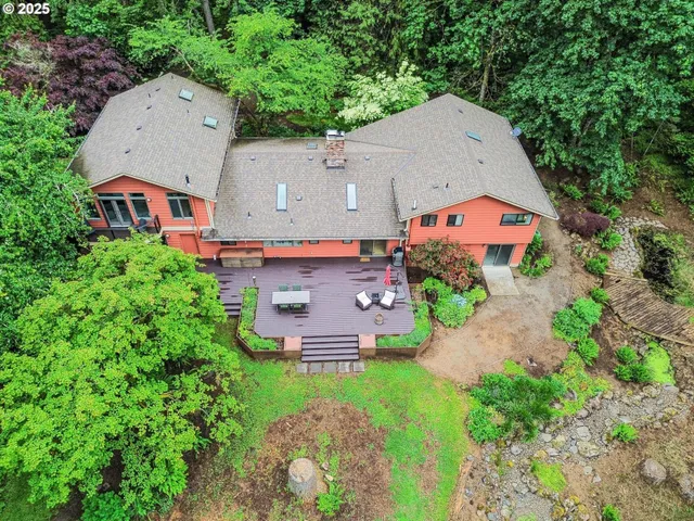 an aerial view of a house with yard and outdoor seating