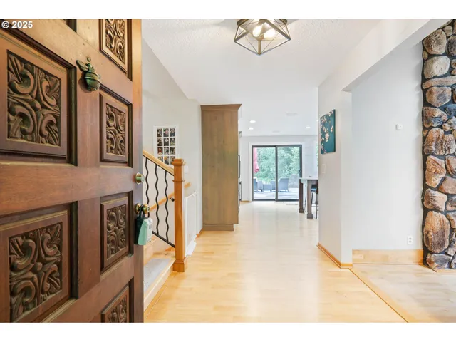 a view of a livingroom with furniture and a hallway