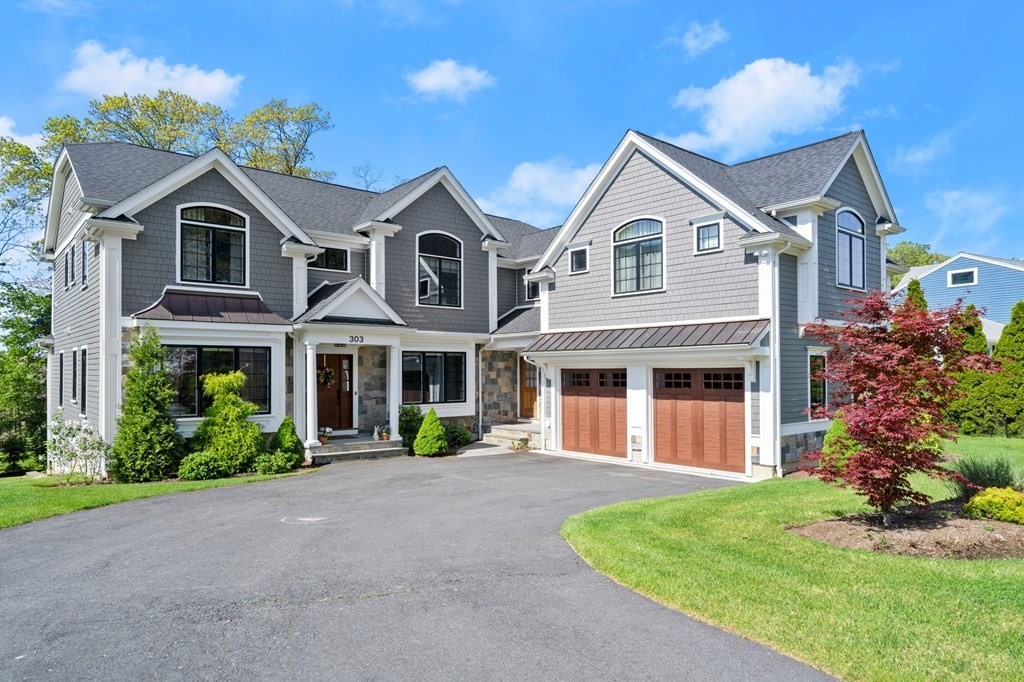 303 Hartman Road Newton, MA 02459 - Photo 1 of 39 a view of a white house with a yard and plants