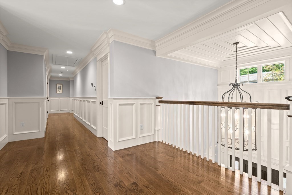 303 Hartman Road Newton, MA 02459 - Photo 15 of 39 a view of a hallway with wooden floor and staircase