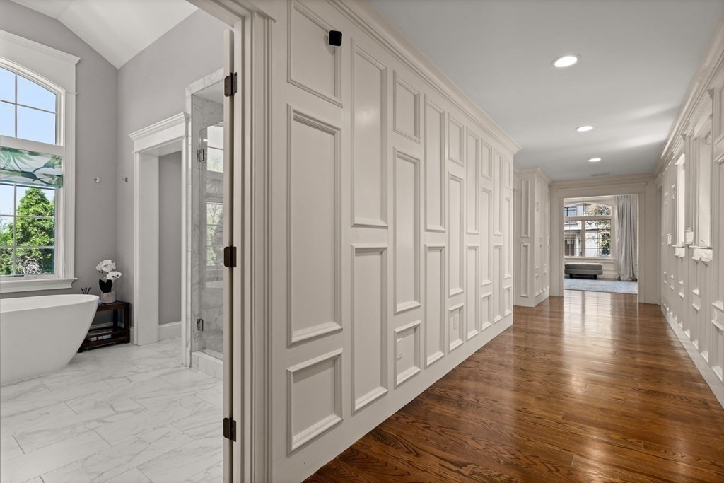 303 Hartman Road Newton, MA 02459 - Photo 17 of 39 a view of a hallway with wooden floor and windows