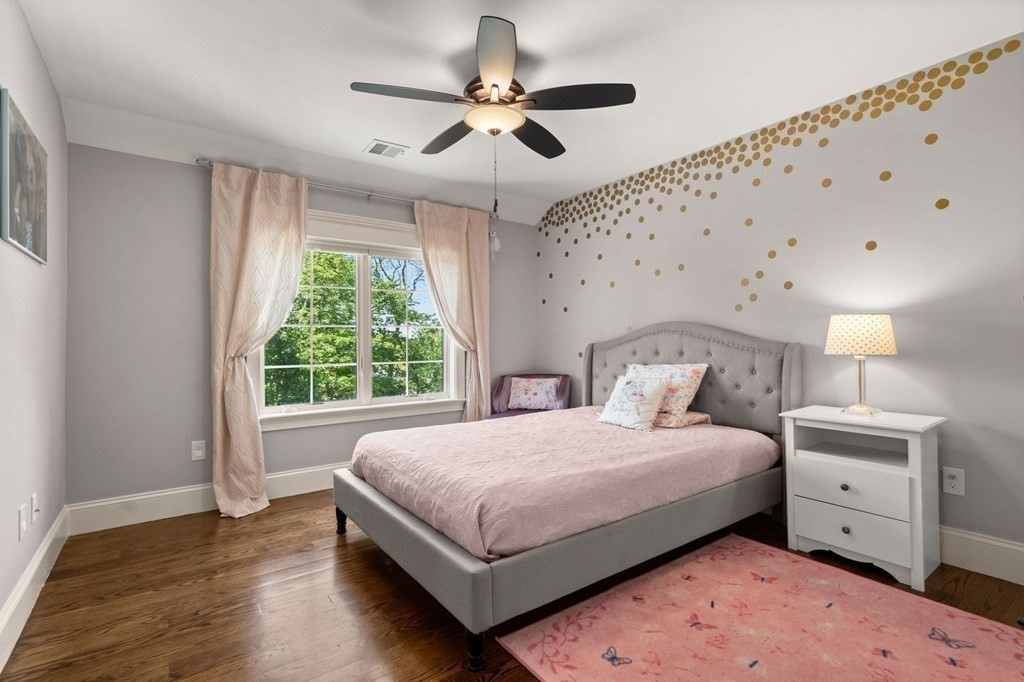 303 Hartman Road Newton, MA 02459 - Photo 21 of 39 a bedroom with a bed chandelier and a window