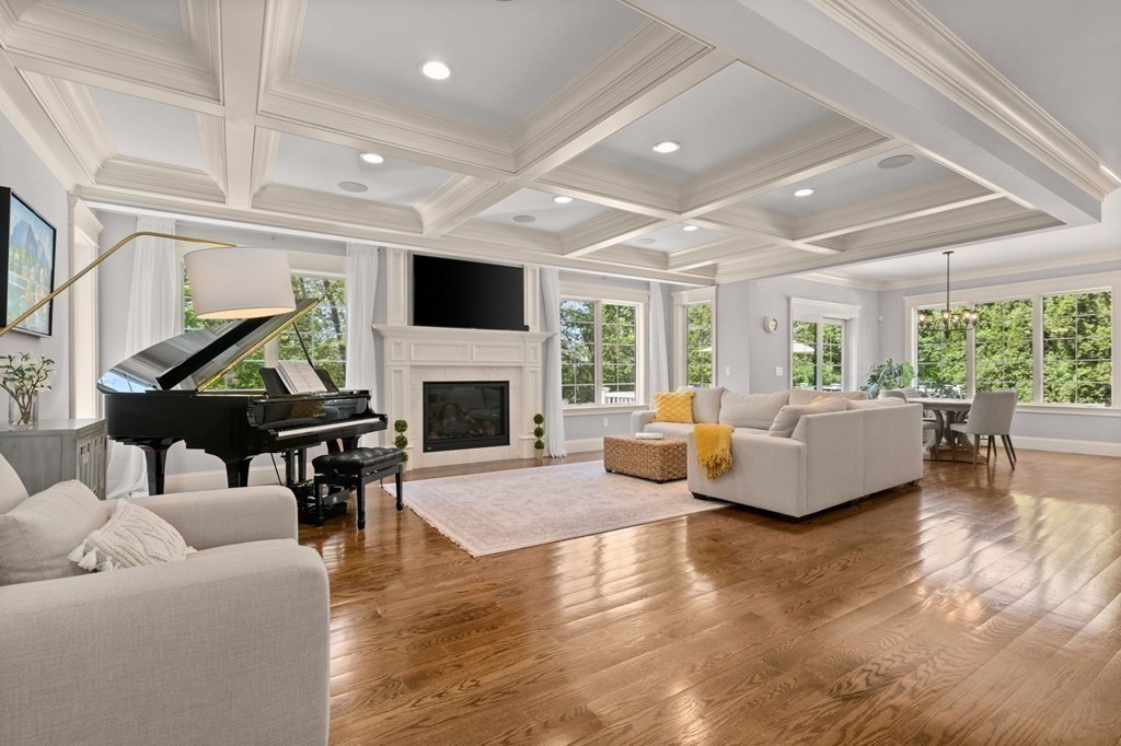 303 Hartman Road Newton, MA 02459 - Photo 3 of 39 a living room with furniture a fireplace and a flat screen tv