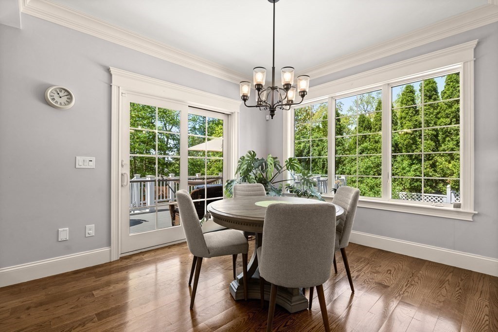 303 Hartman Road Newton, MA 02459 - Photo 4 of 39 a dining room with furniture a chandelier and wooden floor