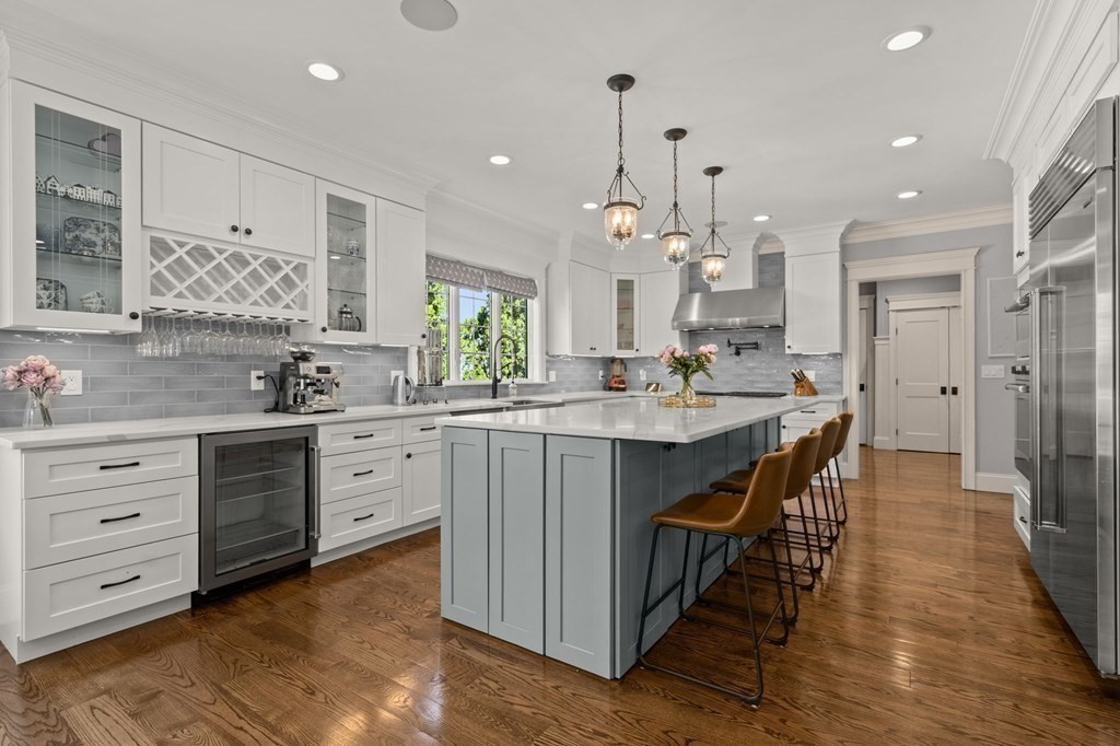 303 Hartman Road Newton, MA 02459 - Photo 5 of 39 a kitchen with kitchen island granite countertop a sink cabinets and wooden floor
