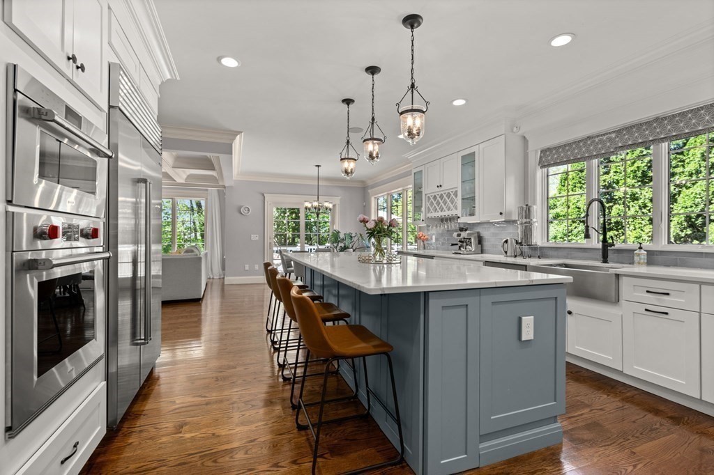 303 Hartman Road Newton, MA 02459 - Photo 6 of 39 a kitchen with stainless steel appliances granite countertop a sink a stove a refrigerator and island with wooden floor