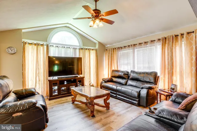 a living room with furniture and a ceiling fan
