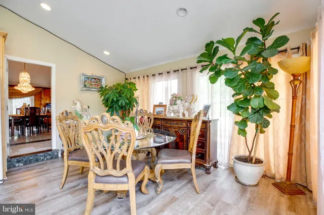 a dining room with furniture and a chandelier