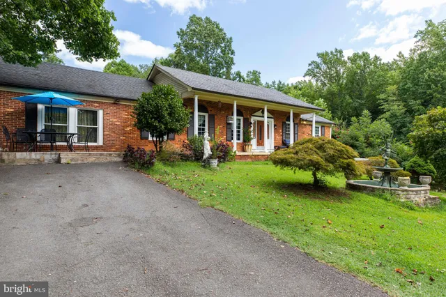 a view of a house with a yard and sitting area