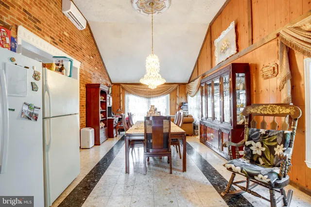 a view of a dining room with furniture and chandelier