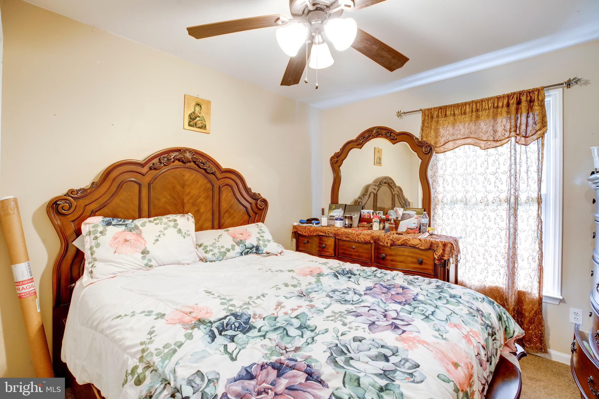 10009 Bent Tree Lane Manassas, VA 20111 - Photo 24 of 41 a bedroom with a bed and a dresser