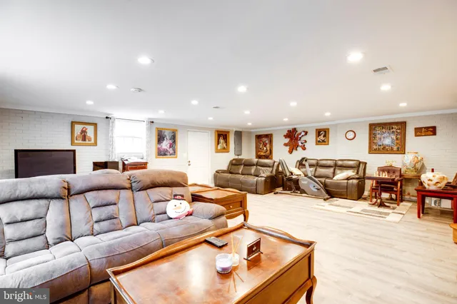 a living room with furniture window and a flat screen tv