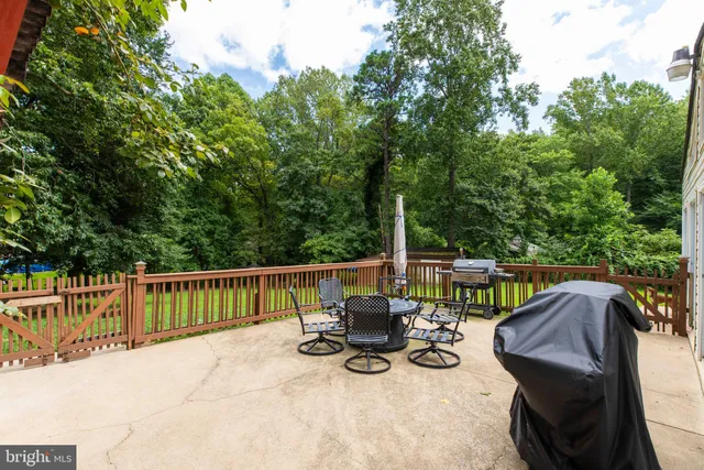 a view of a house with a big yard and large trees