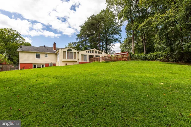 a swimming pool with outdoor seating and yard
