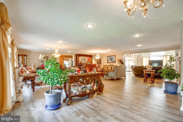 a living room with furniture and a chandelier