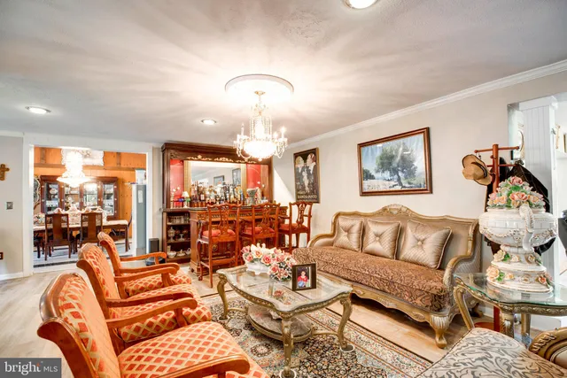 a view of a dining room with furniture wooden floor and chandelier