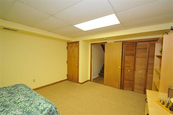 17 Treasure Way, Unit 17 Ashland, MA 01721 - Photo 25 of 27 a bedroom with a bed and wooden floor