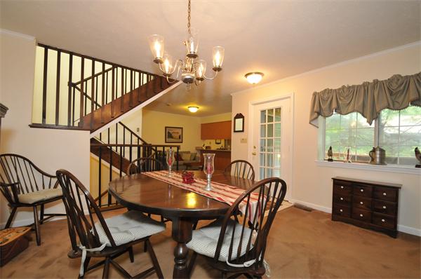 17 Treasure Way, Unit 17 Ashland, MA 01721 - Photo 4 of 27 a dining room with furniture a chandelier and wooden floor