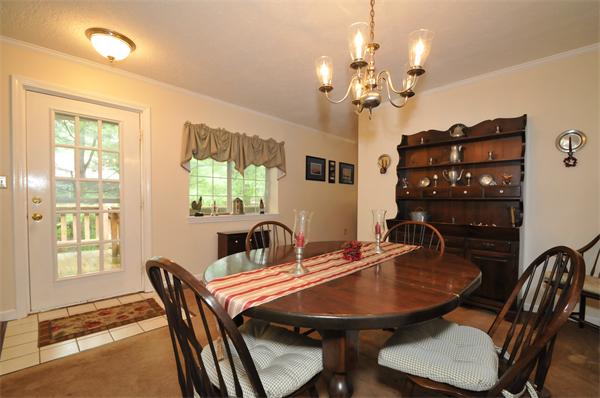 17 Treasure Way, Unit 17 Ashland, MA 01721 - Photo 5 of 27 a dining room with wooden floor a chandelier a glass table and chairs