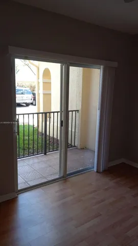 a view of wooden floor and windows in a room
