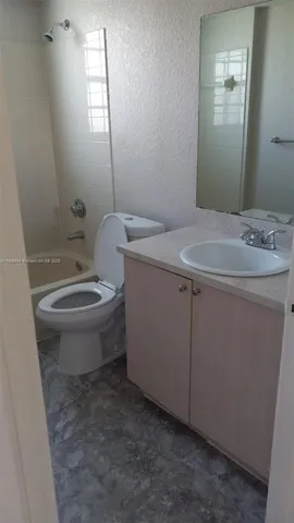 a bathroom with a sink toilet and mirror