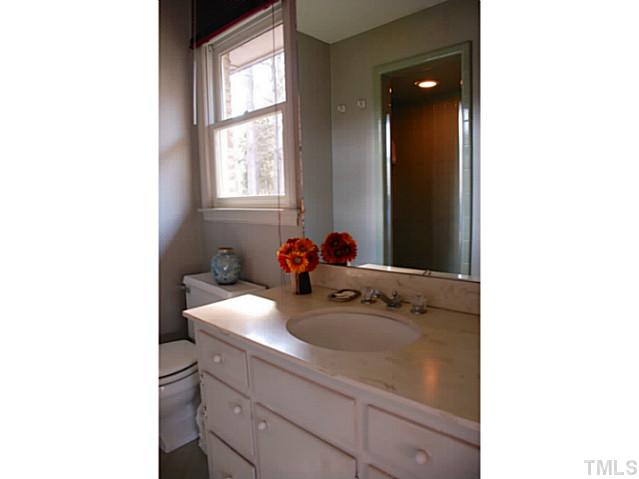 1507 Stonehurst Road Raleigh, NC 27607 - Photo 11 of 23 a bathroom with a sink and a mirror