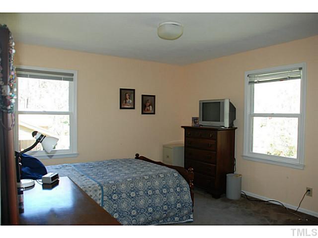 1507 Stonehurst Road Raleigh, NC 27607 - Photo 12 of 23 a bedroom with a bed and a window