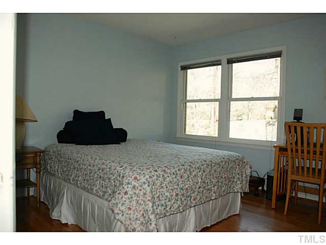 1507 Stonehurst Road Raleigh, NC 27607 - Photo 13 of 23 a bedroom with a bed with chair