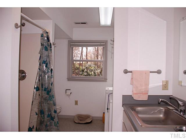 1507 Stonehurst Road Raleigh, NC 27607 - Photo 17 of 23 a bathroom with a sink a toilet and shower