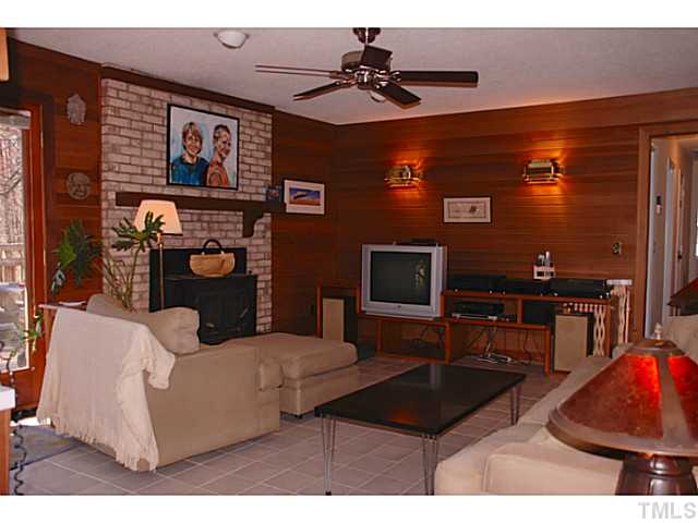 1507 Stonehurst Road Raleigh, NC 27607 - Photo 7 of 23 a living room with furniture and a flat screen tv