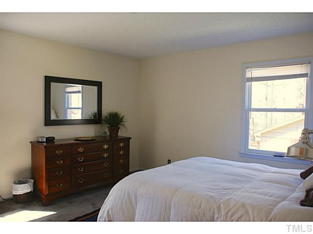 1507 Stonehurst Road Raleigh, NC 27607 - Photo 8 of 23 a bedroom with a bed and a dresser