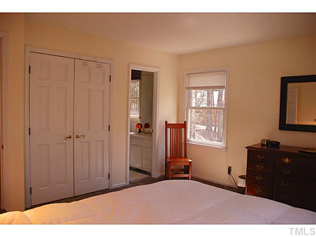 1507 Stonehurst Road Raleigh, NC 27607 - Photo 9 of 23 a bedroom with a bed and a mirror