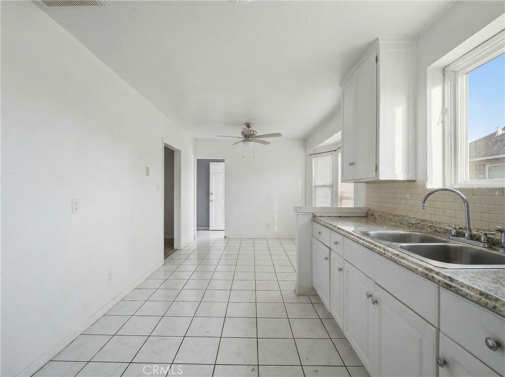 12817 Zeus Avenue Norwalk, CA 90650 - Photo 11 of 36 a kitchen with a sink and cabinets